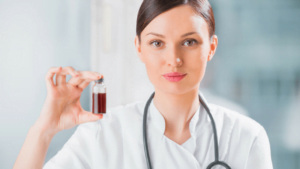 A doctor holding a small jar of CBD oil.