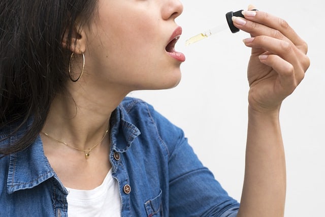 woman consuming cbd oil