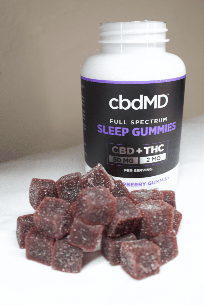 cbdMD Review - CBD Sleep Gummies - Bottle with Gummies Foreground